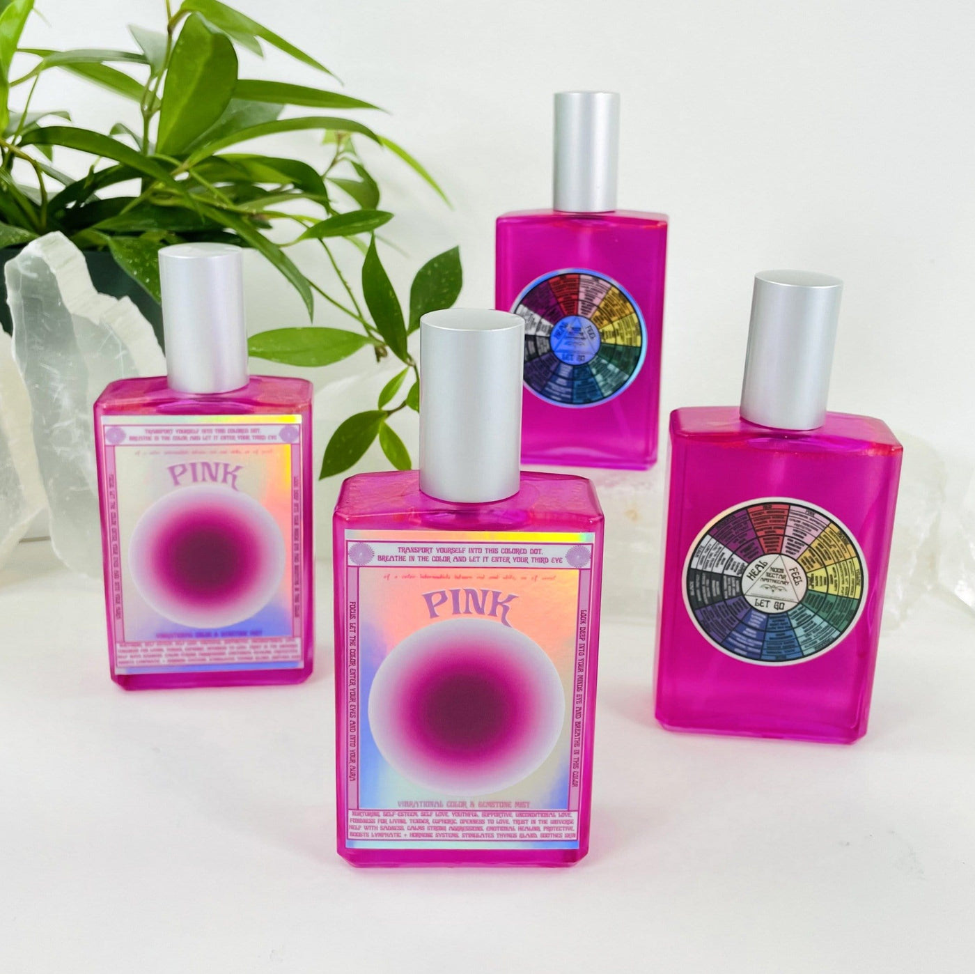 4 bottles of Gemstone Mist - Pink Vibrational Color  with decorations in the background