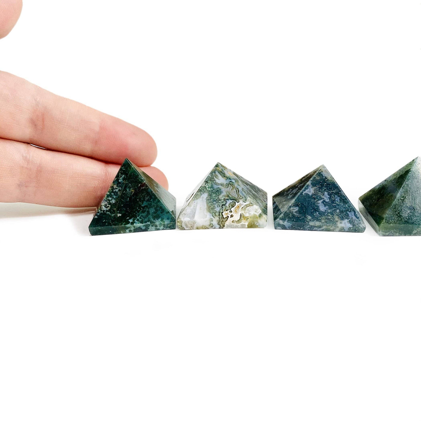 Moss agate assorted pyramids on a white background.  