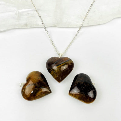 tigers eye heart on a chain and 2 next to it