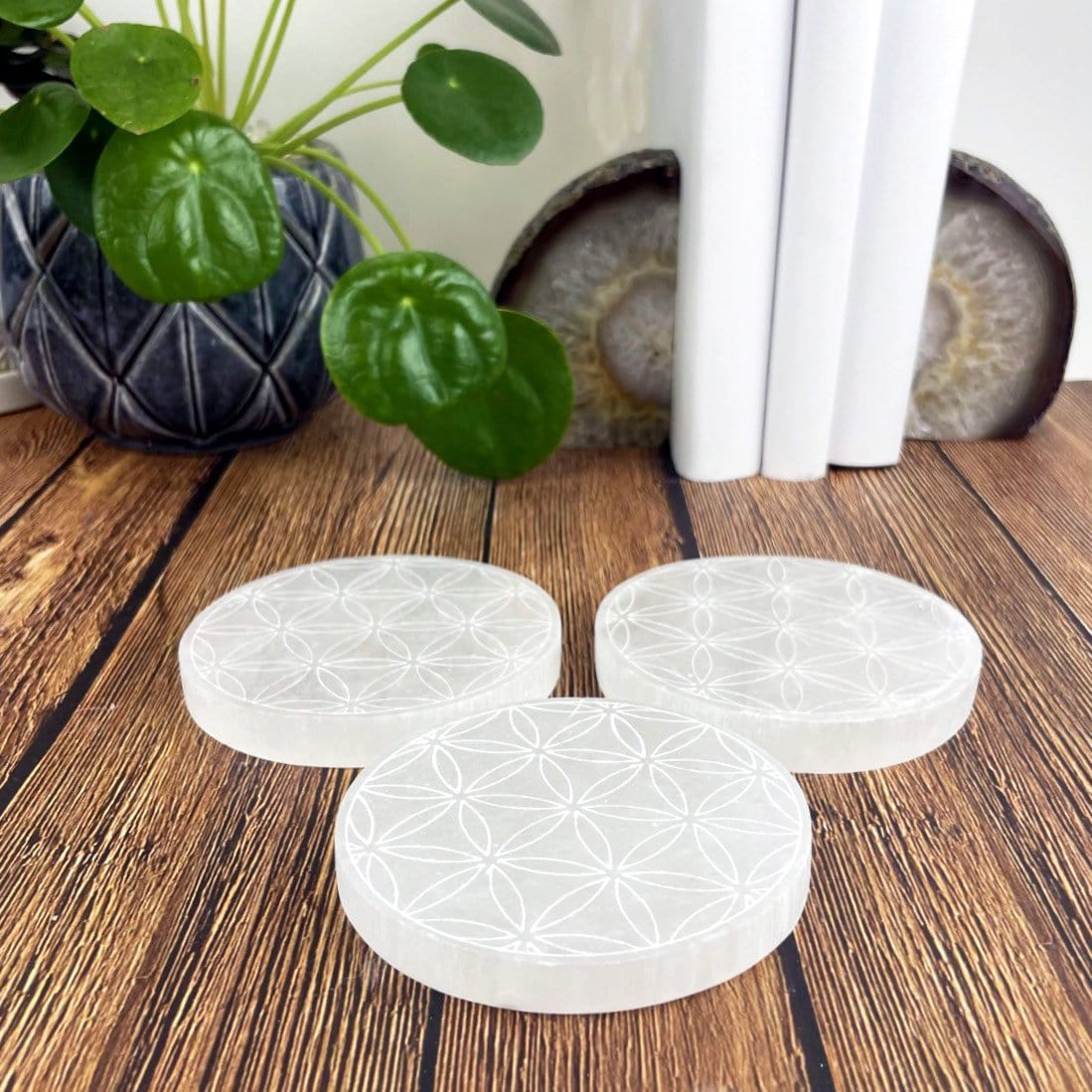 side view of selenite round plates engraved with flower of life for thickness