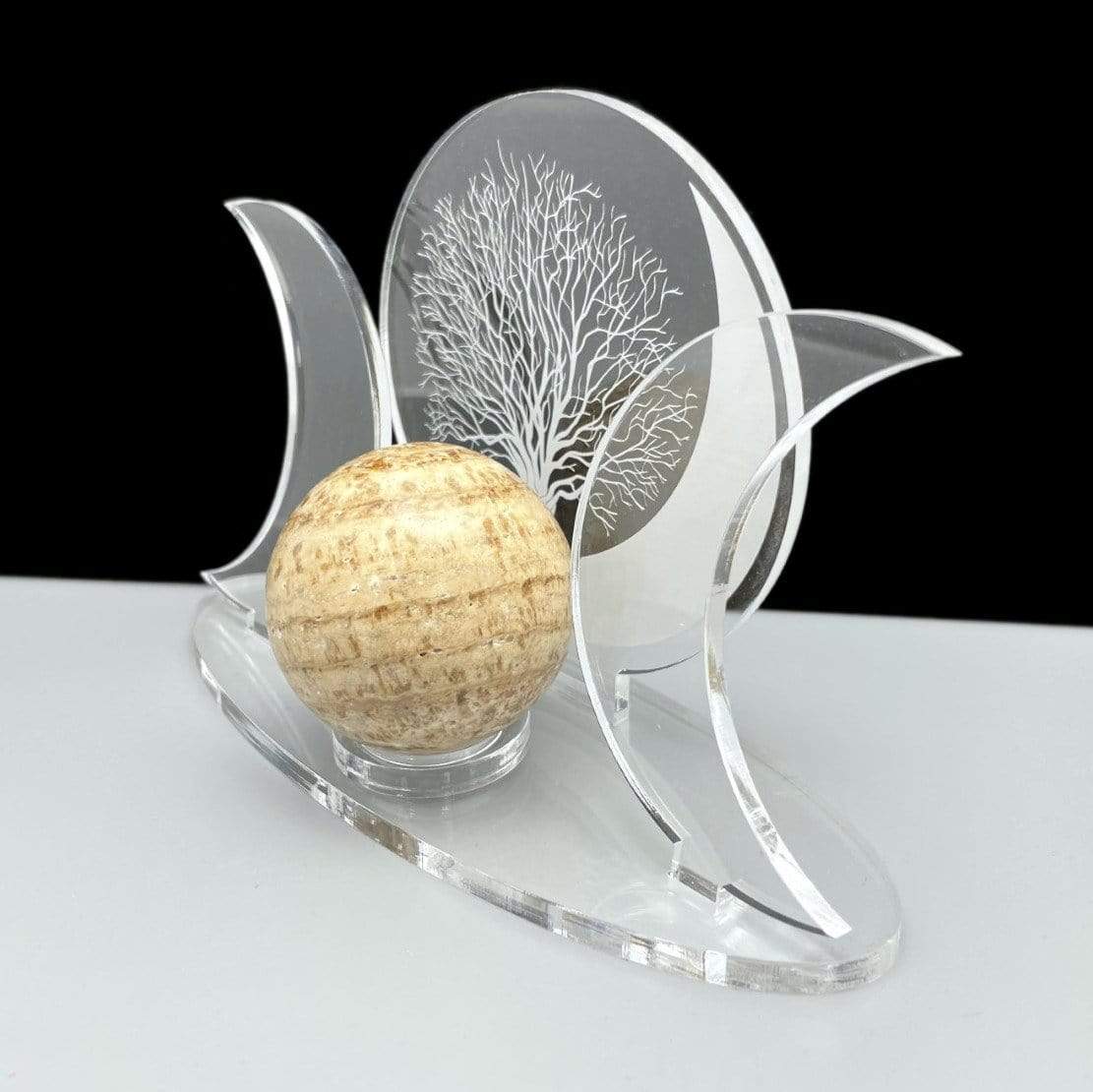 An angled view of an Acrylic Sphere Holder Crescent Moons - Tree of Life holding a sphere.