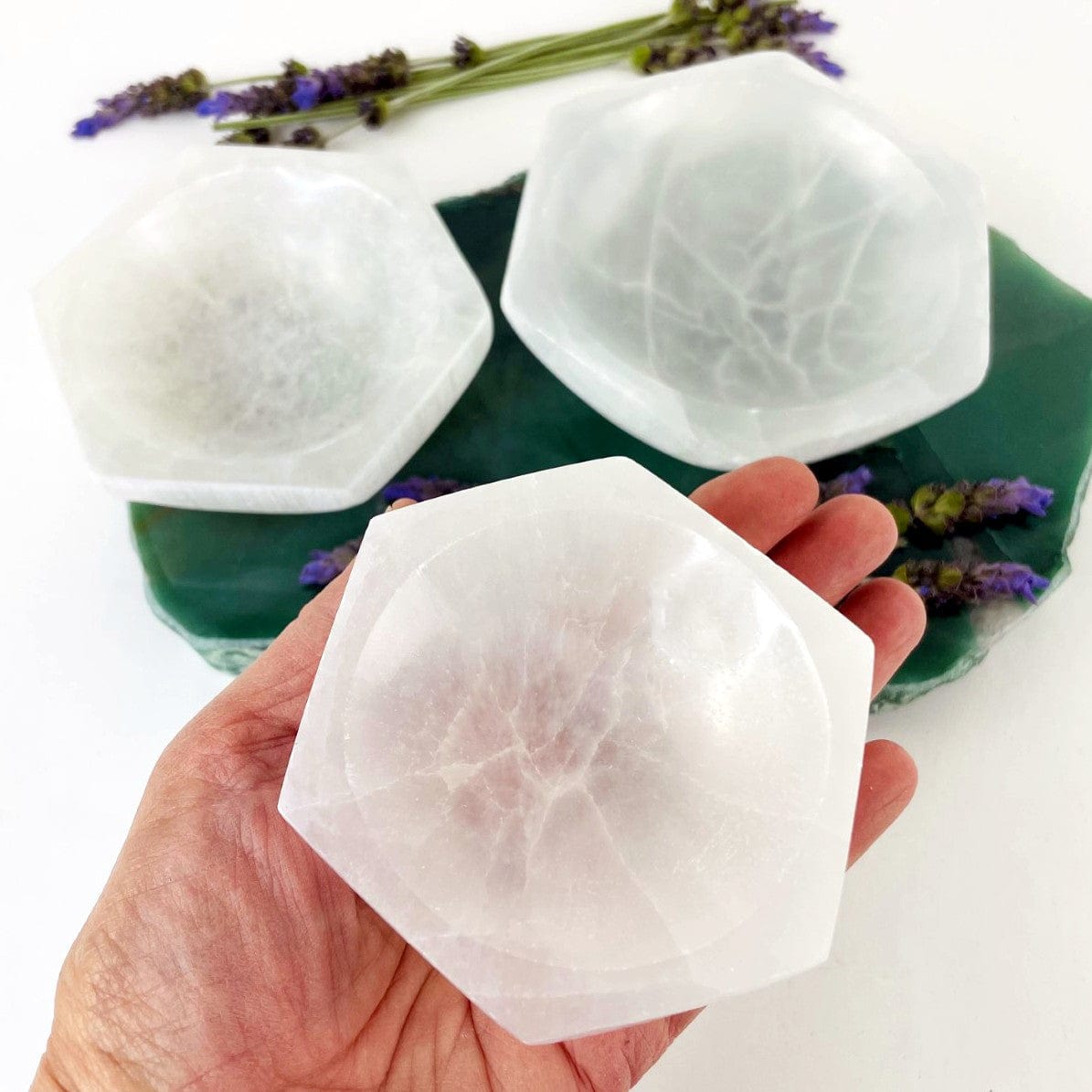 hexagon selenite bowl in hand for size reference with others on display