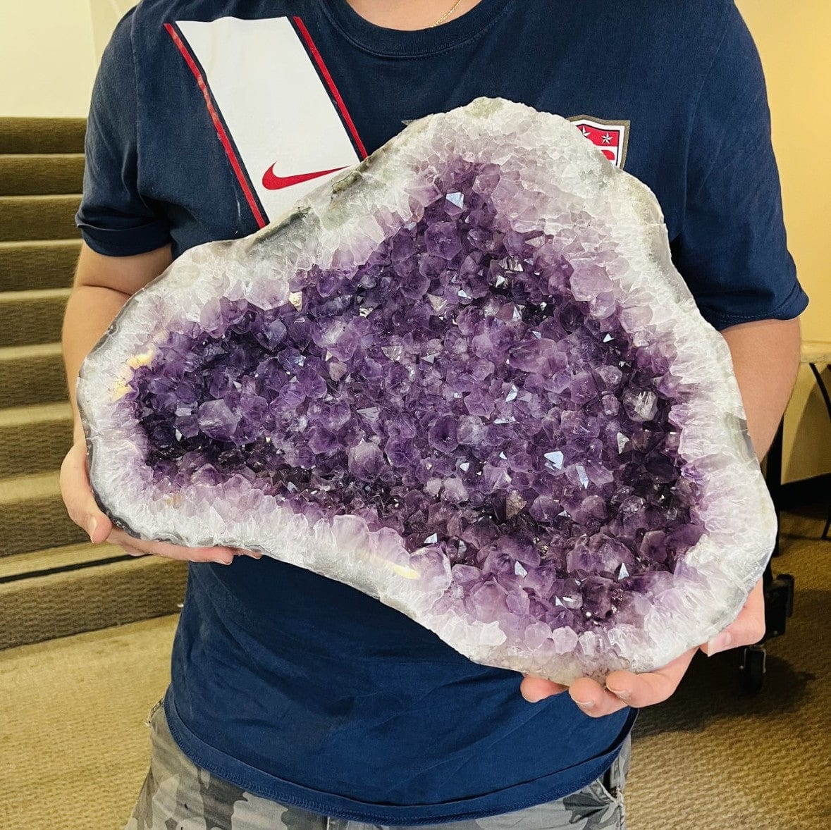 Amethyst Polished Cave Geode lid in a mans hands