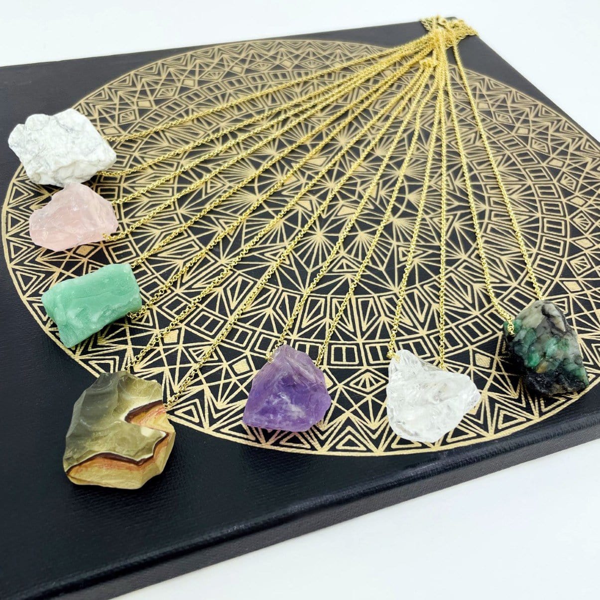 Healing Stone Necklaces with gold chain on crystal grid