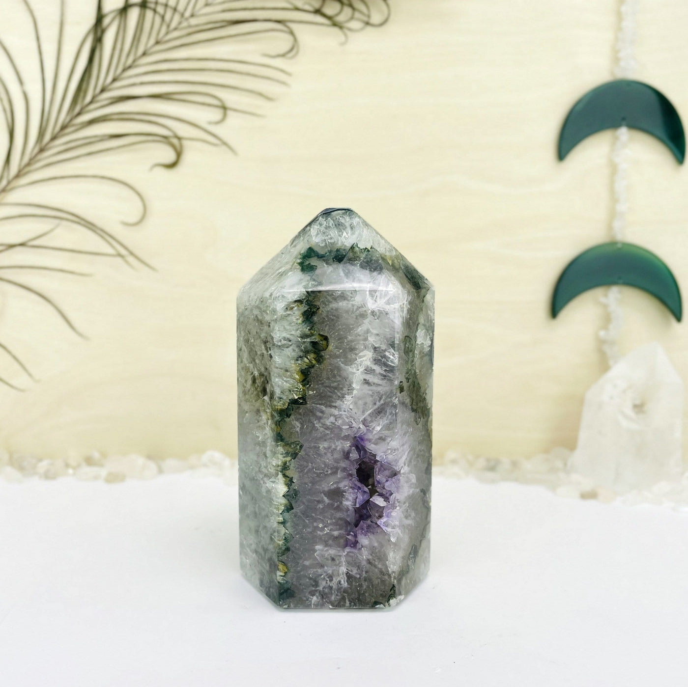 agate and amethyst polished tower. It is mostly white with green banding and a purple druzy cluster opening at the bottom.