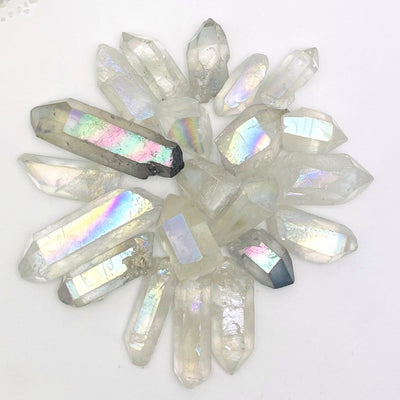 crystal quartz points coated in angel aura showing the different colors and size variations