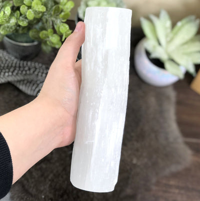 side view of 3 votive selenite candle holder in hand for thickness