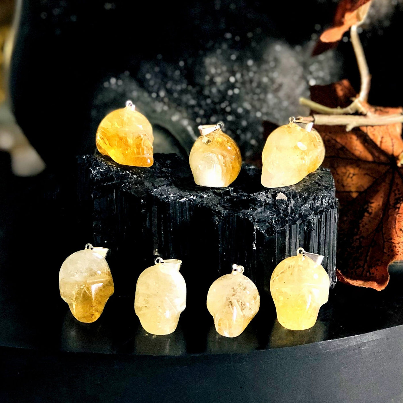 many citrine skull shaped pendants on display for possible variations