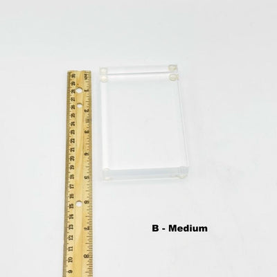 medium thick acrylic crystal display stand next to a ruler for size reference