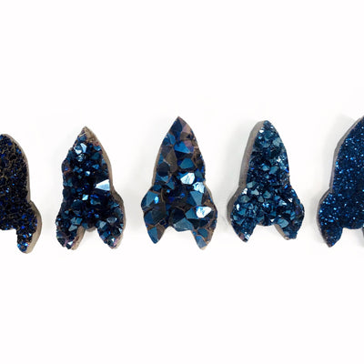 5 mystic blue druzy rockets displayed to show various characteristics