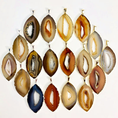Front facing agate druzy marquise shape displaying silver and gold pendants. Color and pattern vary.