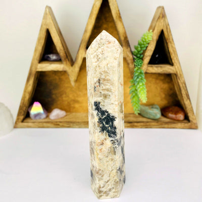 Tourmaline with Feldspar Tower with decorations in the background