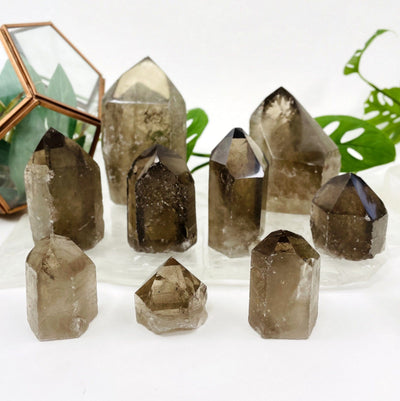many smokey quartz polished points on display for possible variations