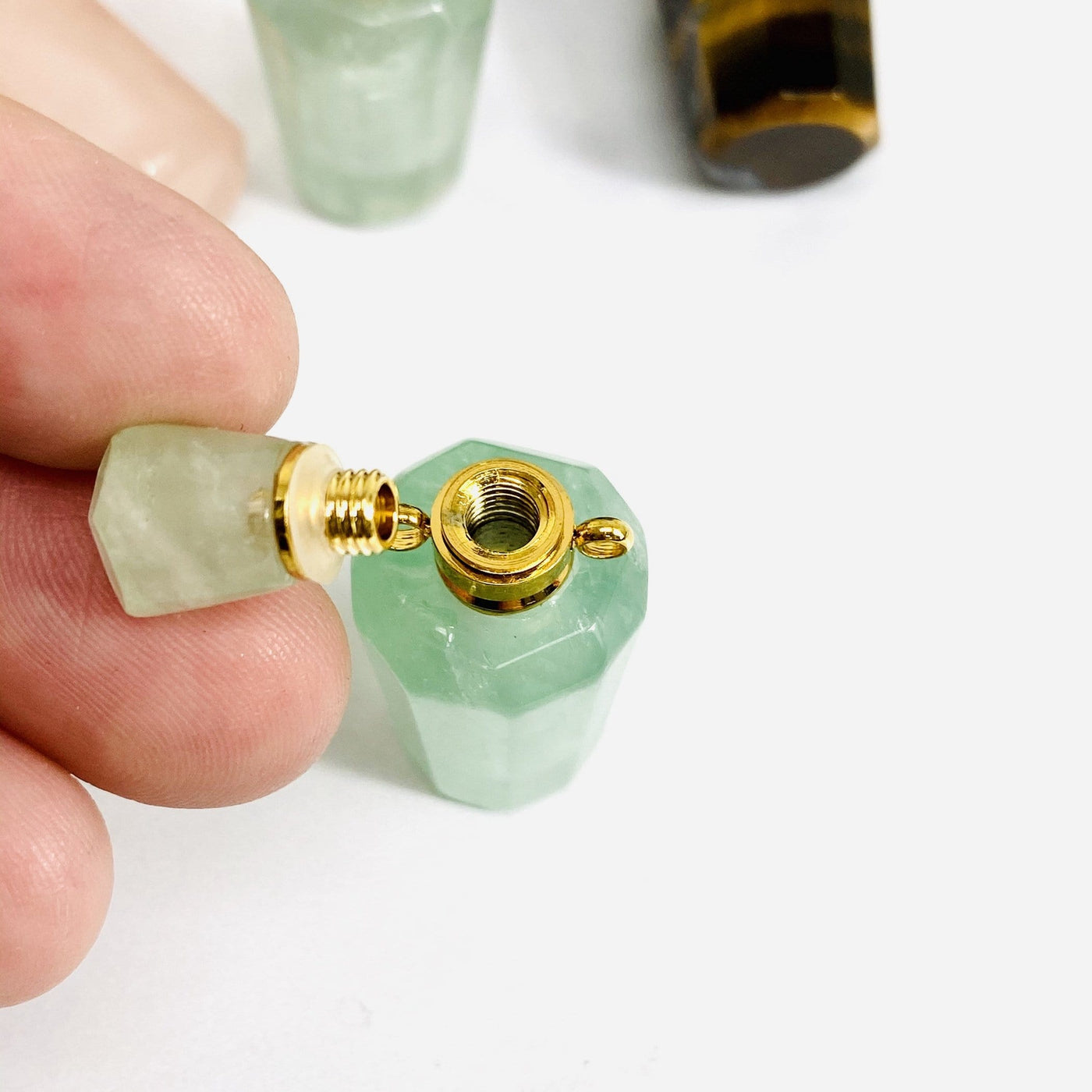 close up of bottle pendant with the top off