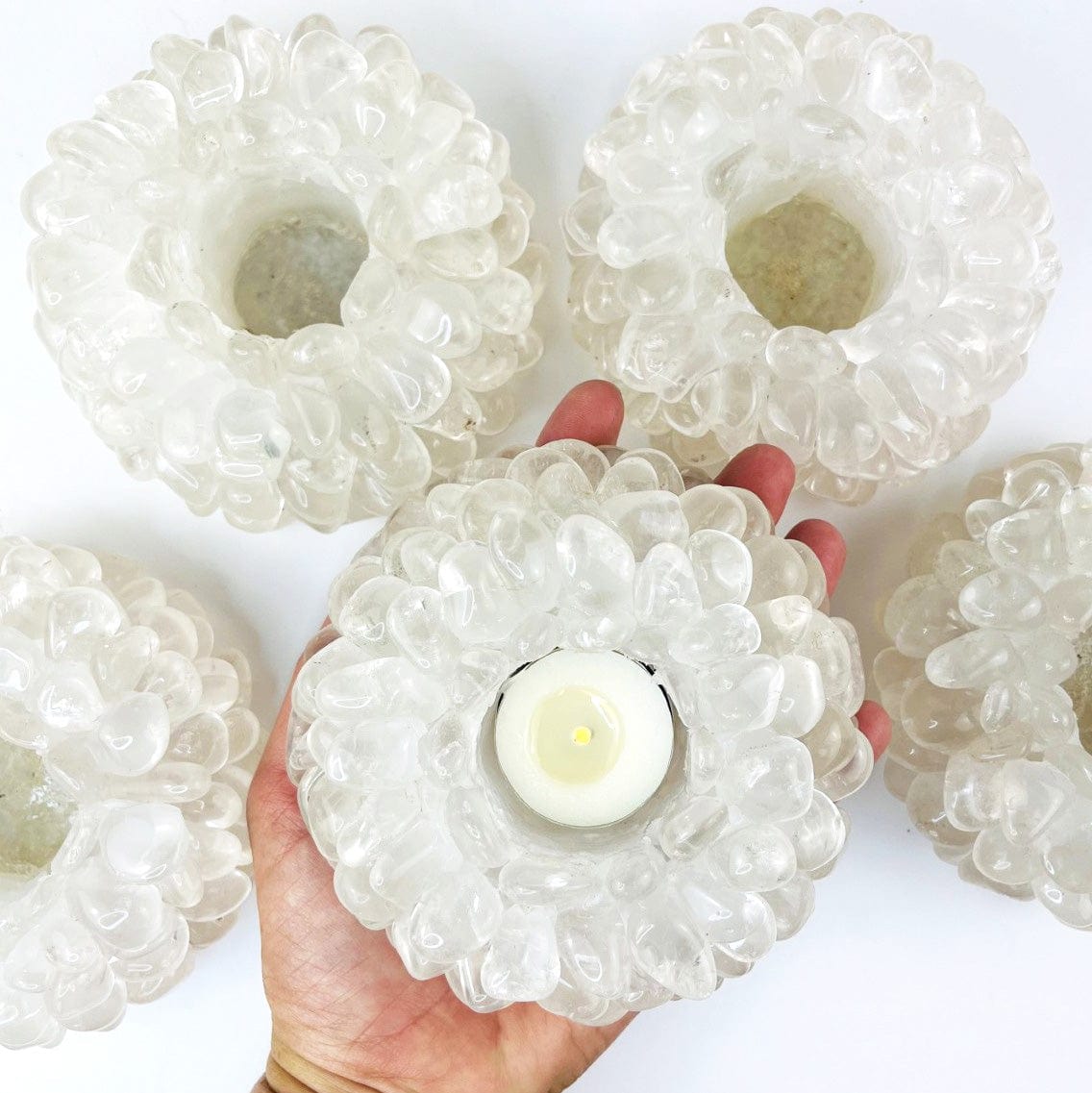 Crystal Quartz Tumbled Stone Candle Holder in a hand for size reference