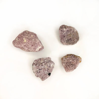 4 Lepidolite Rough stones on white background showing assortment of sizing