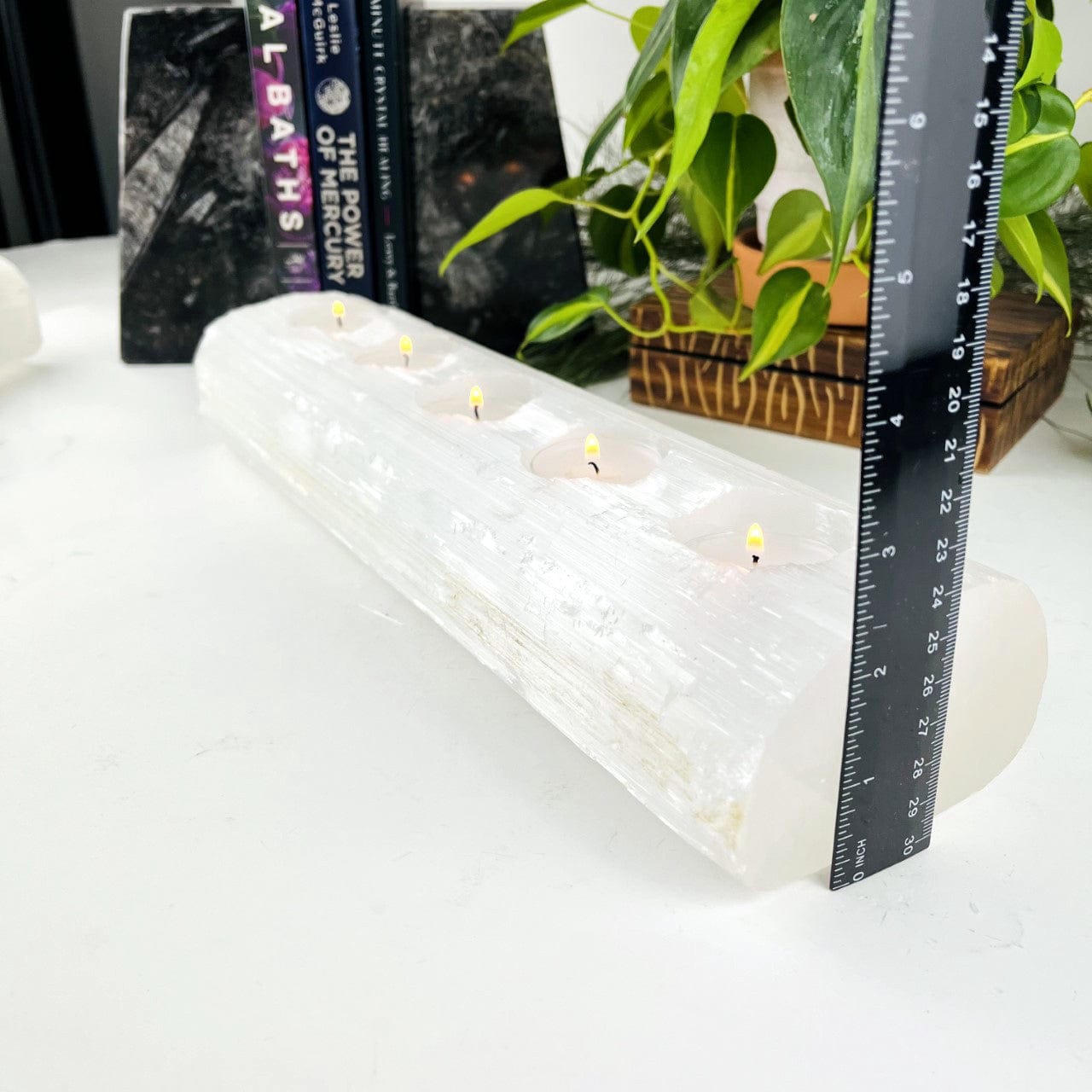 Selenite Candle Holder XL Size with 5 Holes for Votives Lit with a ruler showing how tall