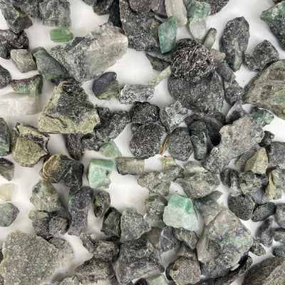 Emerald Stones spread out on a table