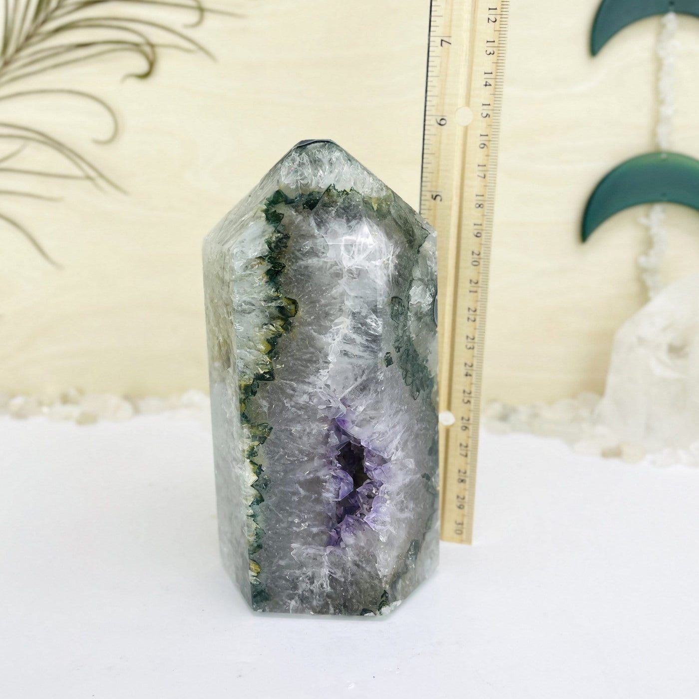 agate and amethyst polished tower. It is mostly white with green banding and a purple druzy cluster opening at the bottom. Shown next to a ruler showing it is almost 6" TALL.