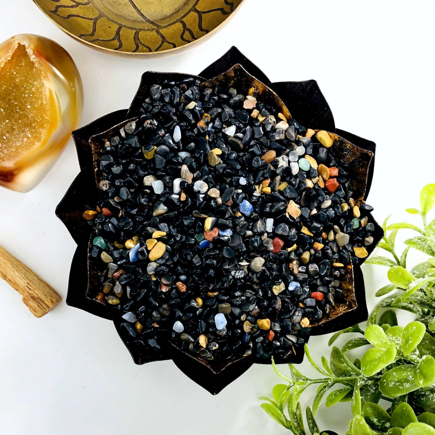 Black onyx chips in a lotus bowl.  They are mixed with a few other colorful stones.