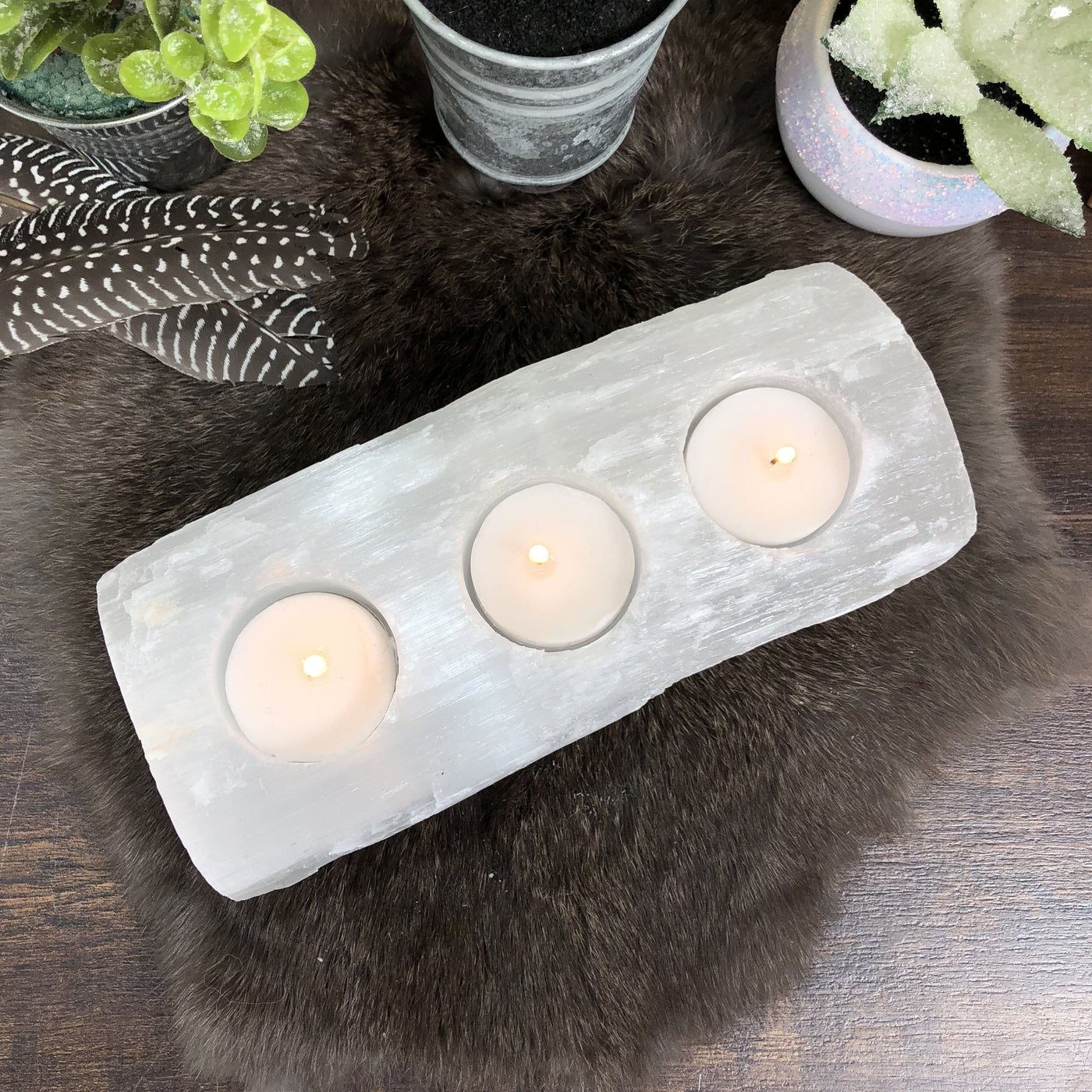 overhead view of 3 votive selenite candle holder with candles (not included with purchase)
