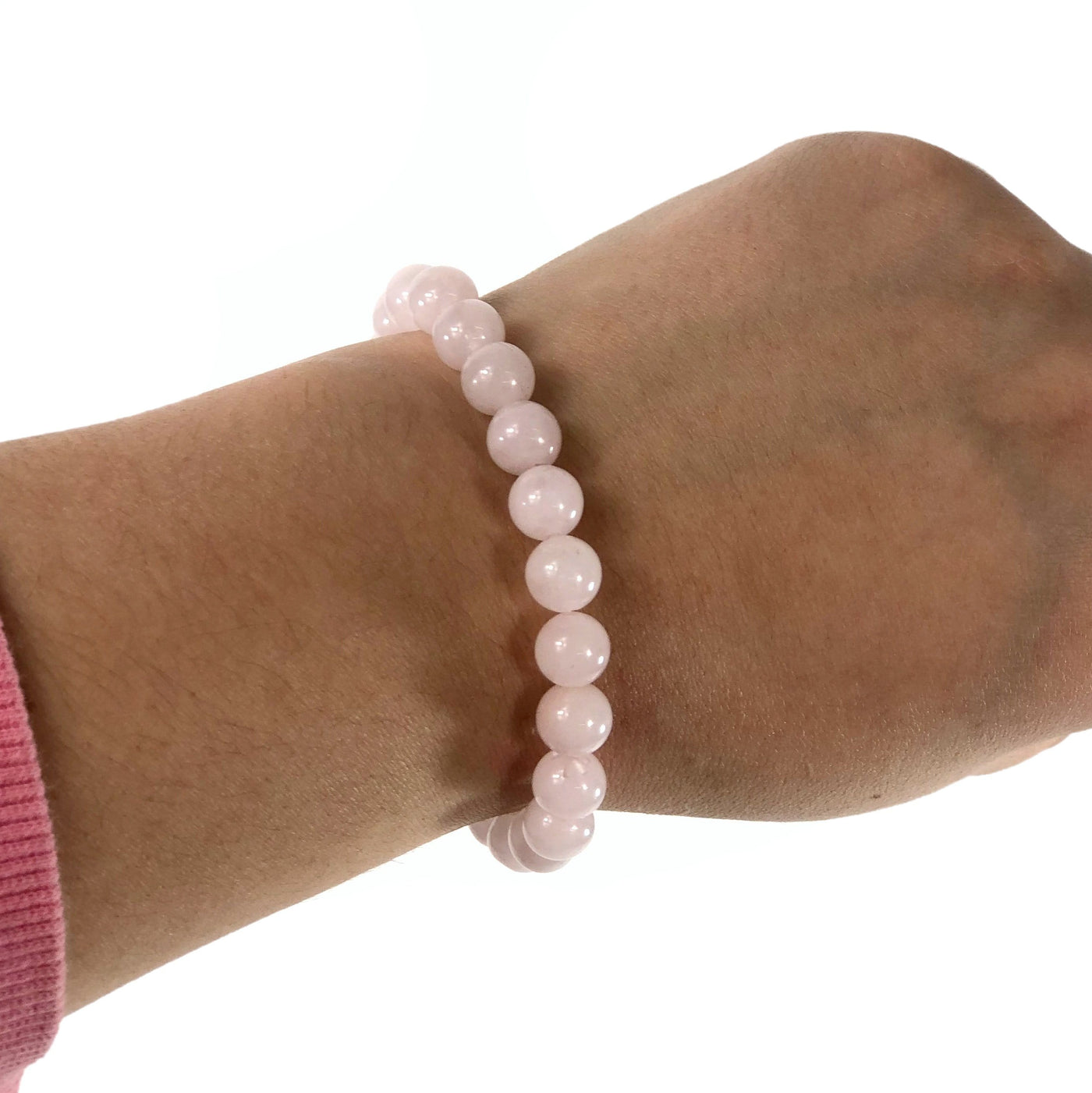 rose quartz healing stone bracelet being worn with white background