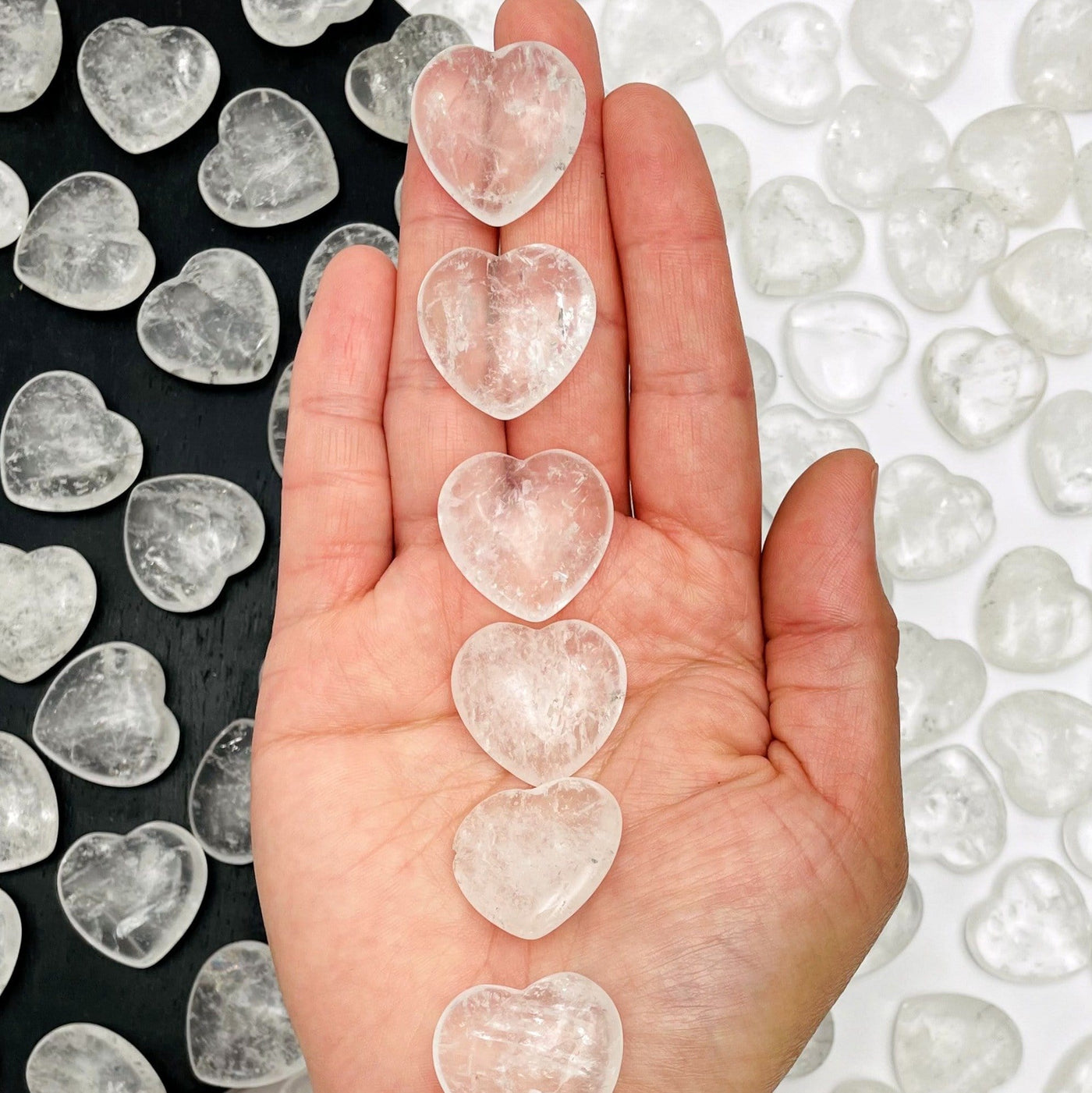 crystal quartz hearts displayed on hand for size reference