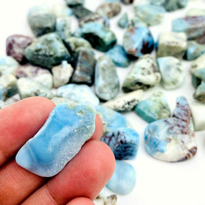 larimar tumbled stone in hand for size reference