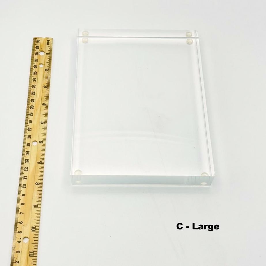 large thick acrylic crystal display stand next to a ruler for size reference