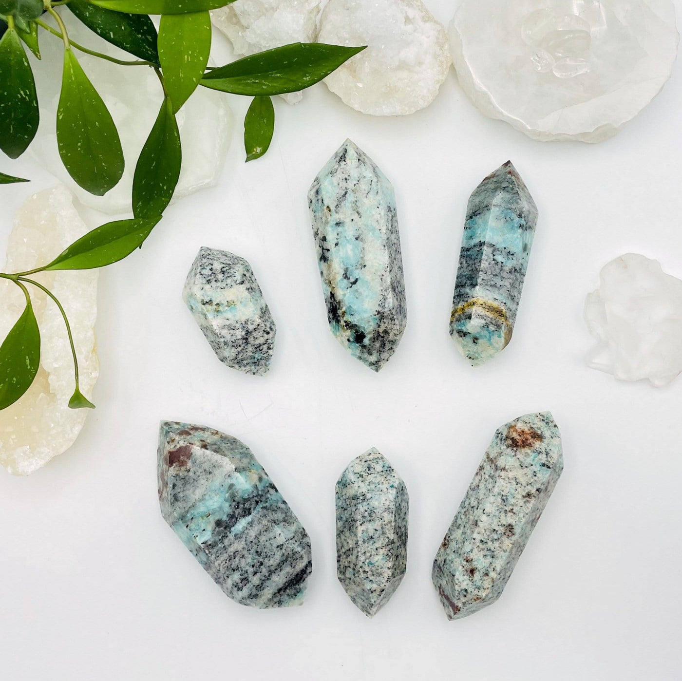 Picture of six double terminated amazonite points on a white background.  