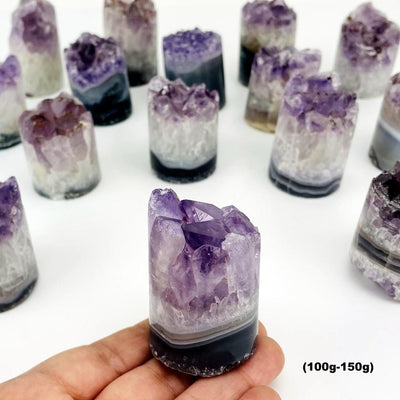 A variety of size 100gram - 150gram amethyst cores on a white background.