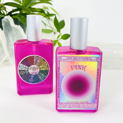 2 bottles of Gemstone Mist - Pink Vibrational Color with decorations in the background