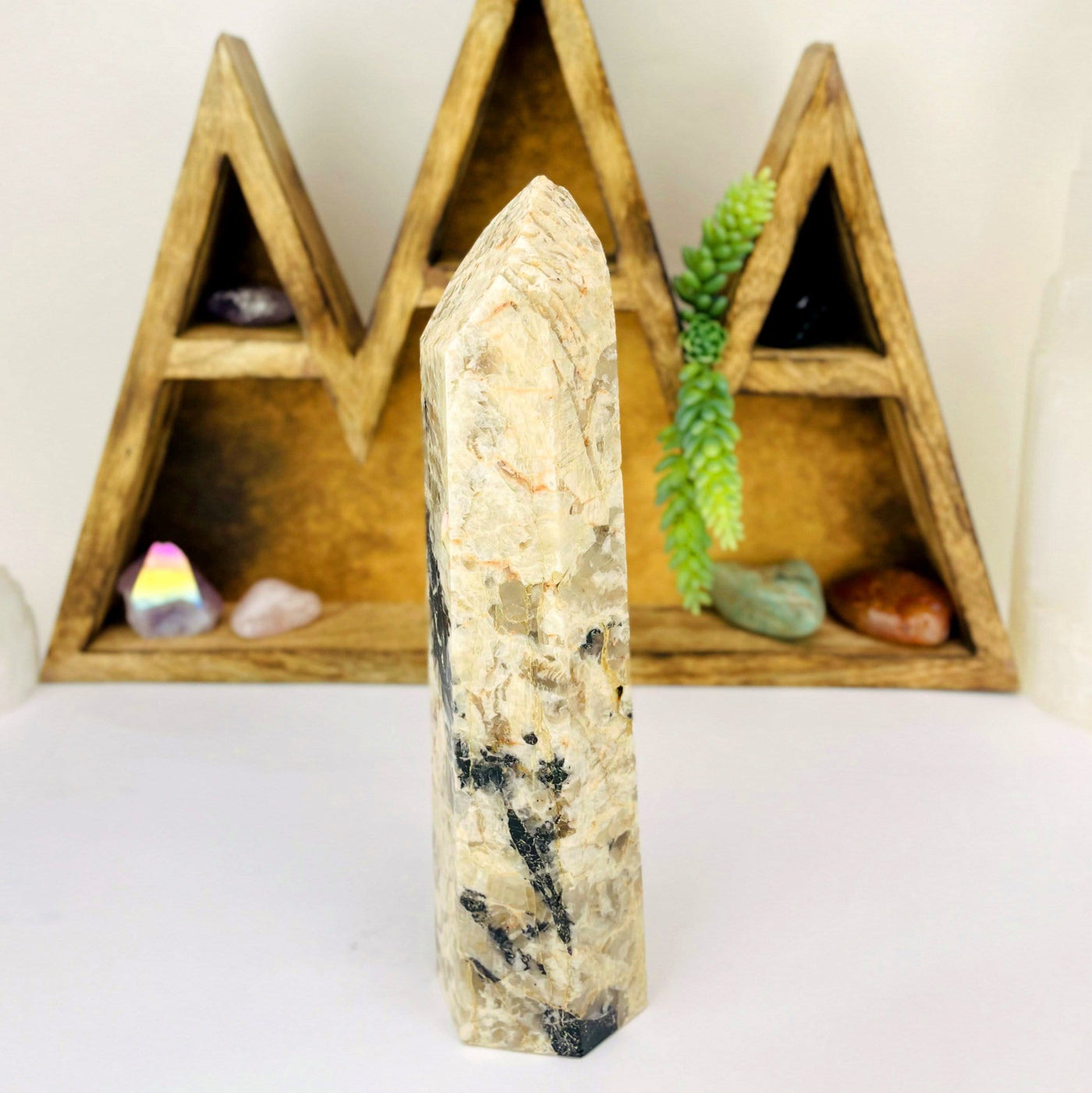 side view of Tourmaline with Feldspar Tower with decorations in the background