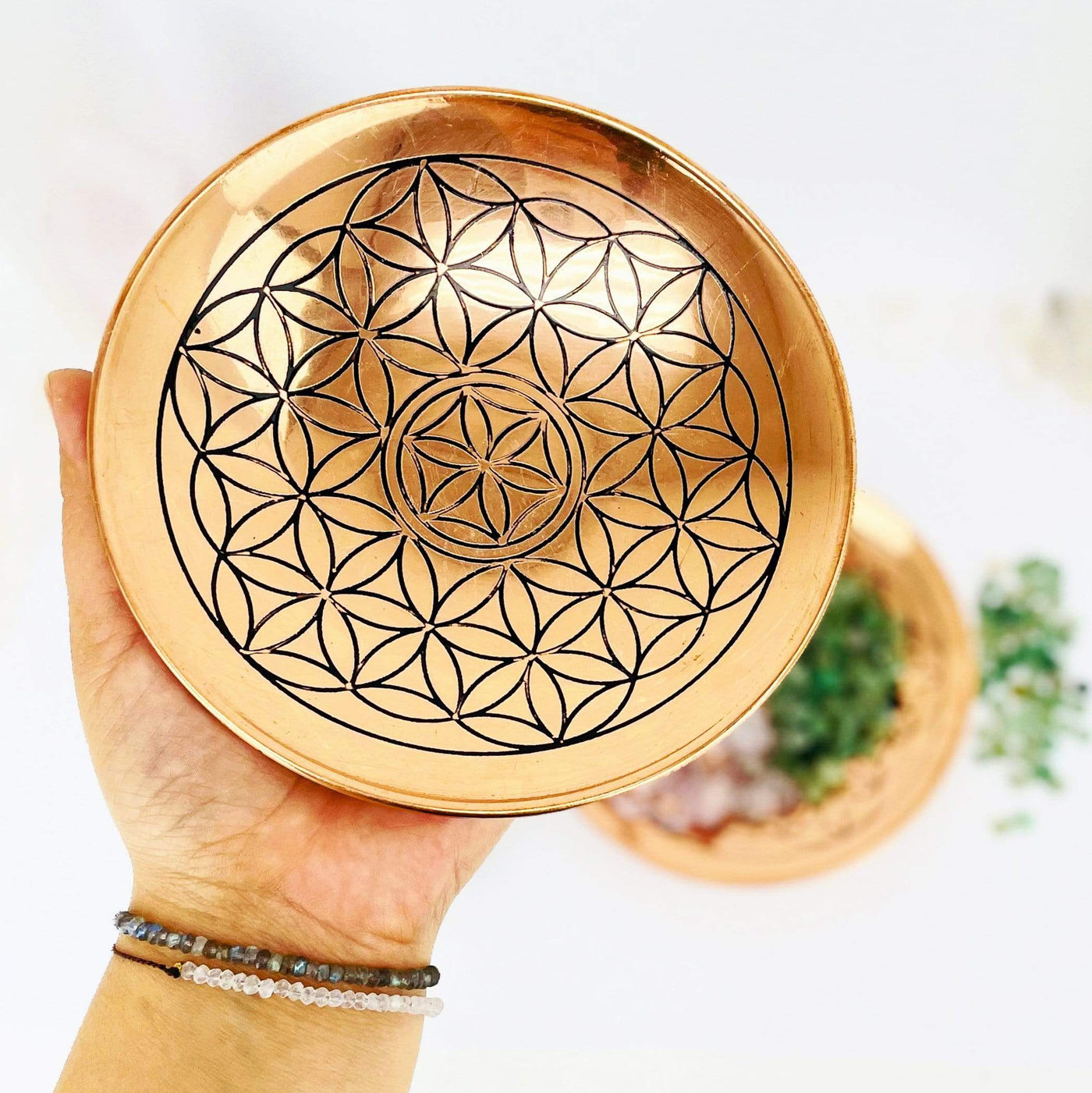 copper offering bowl with flower of life grid in hand for size reference 