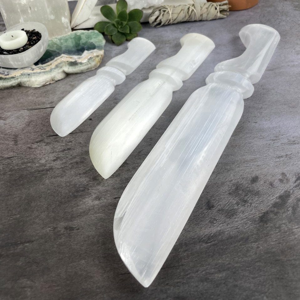 3 sizes of Selenite Knives with Hand Cut and Polished Handles up close on the blade
