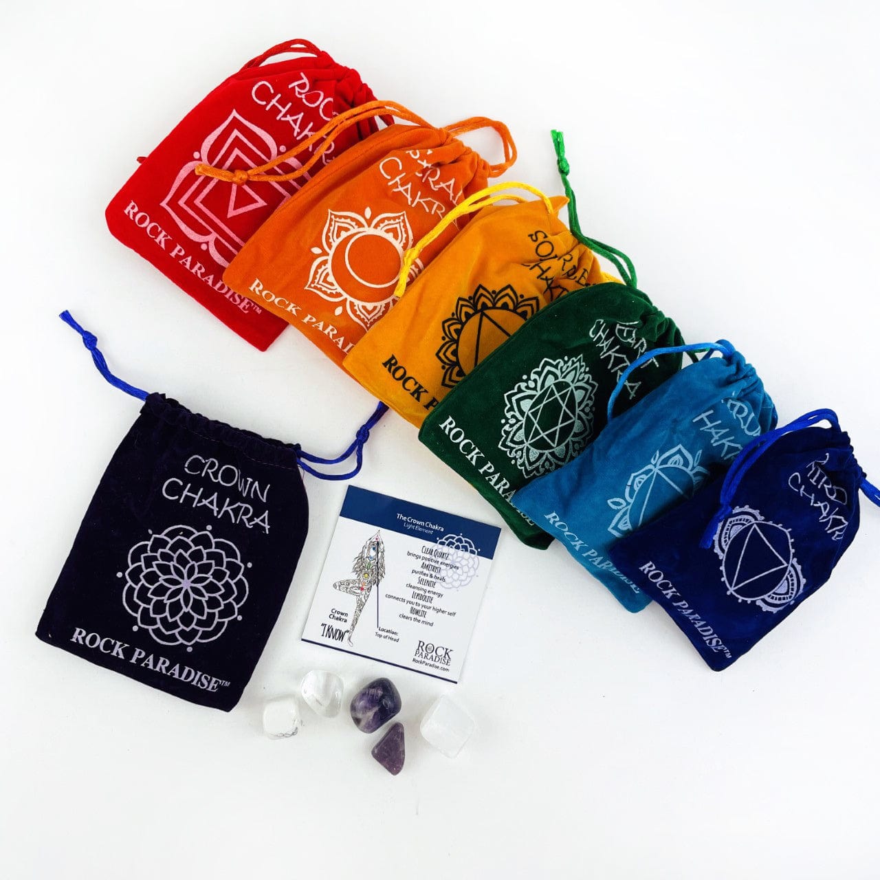 The Crown chakra pouch opened wshowing the information card and tumbled stones, and the other pouch sets behind