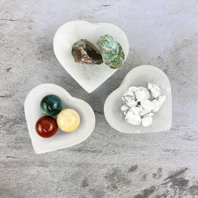 smaller size Selenite Heart Bowls with stones in them