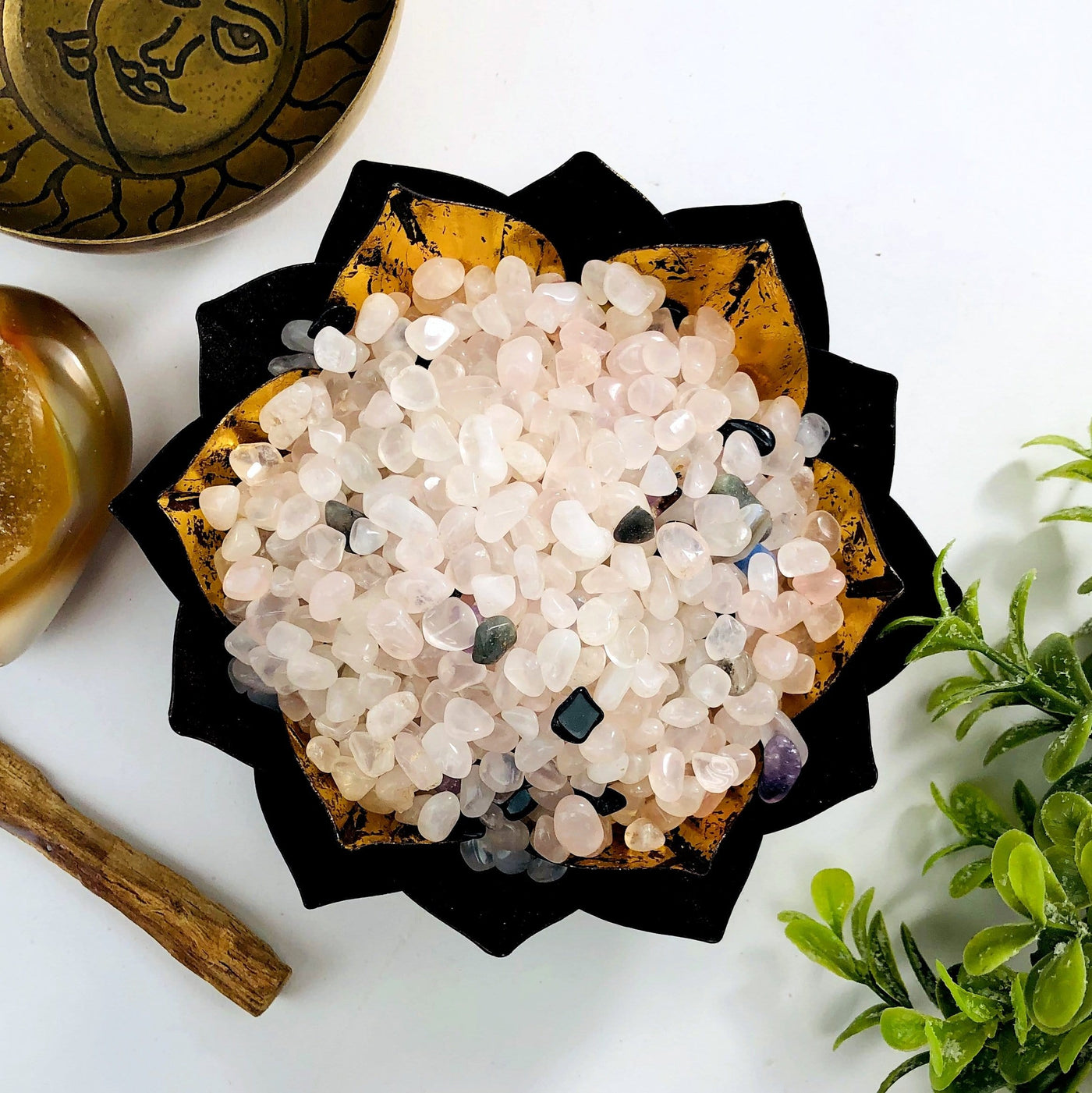 Rose quartz chips in a lotus bowl, a few other stones are in the mix.