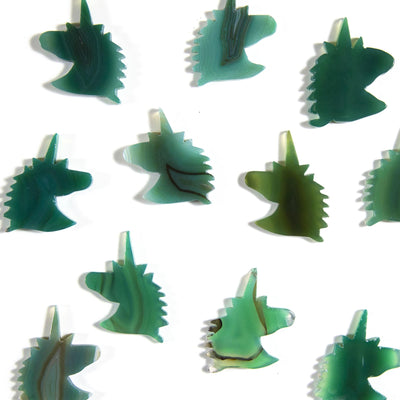 green agate unicorn heads being displayed on a white background.