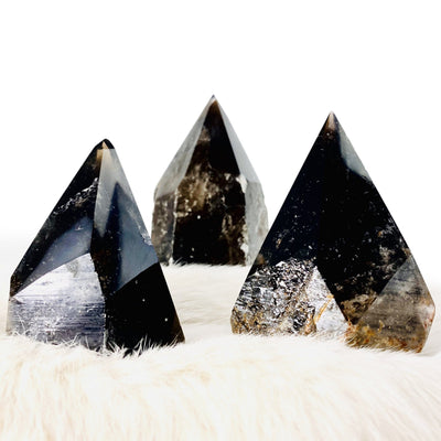 three smokey quartz semi polished points on display for possible variations