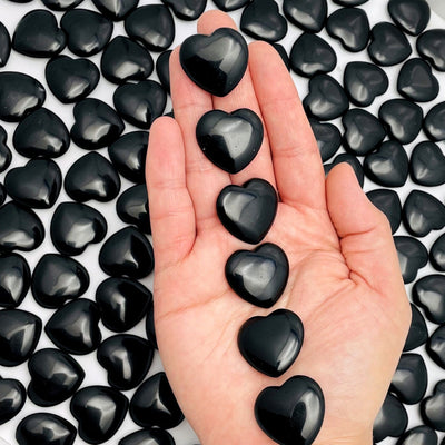 Black Obsidian Hearts  displayed in hand for size reference