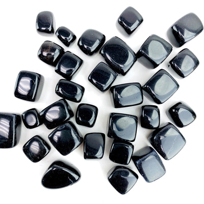 obsidian cubes scattered on white background