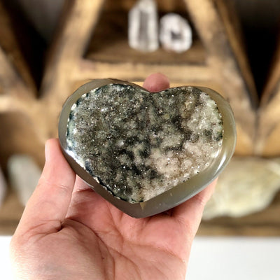 Front facing close up of Agate Druzy Heart (DOOAK-S24-29) in a hand.