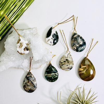 jasper tumbled pendants on a table