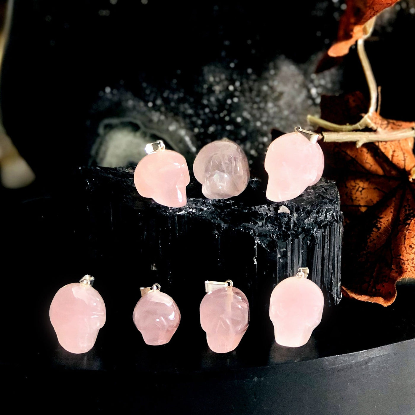 many rose quartz skull shaped pendants on display for possible variations