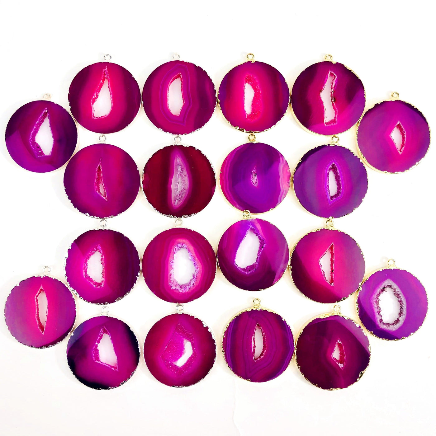 Multiple Pink Agate Circle Slice Pendants to show color and pattern variation.