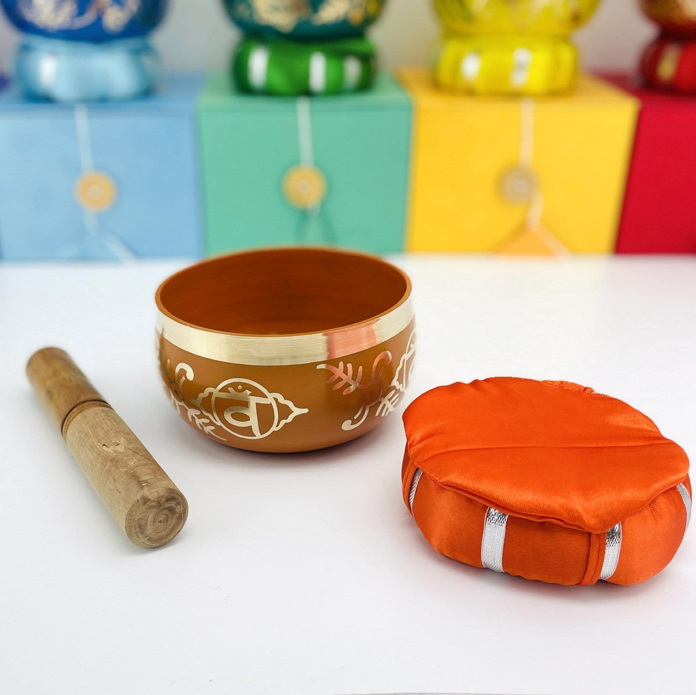 Brass Tibetan Singing Bowls - orange bowl on a table