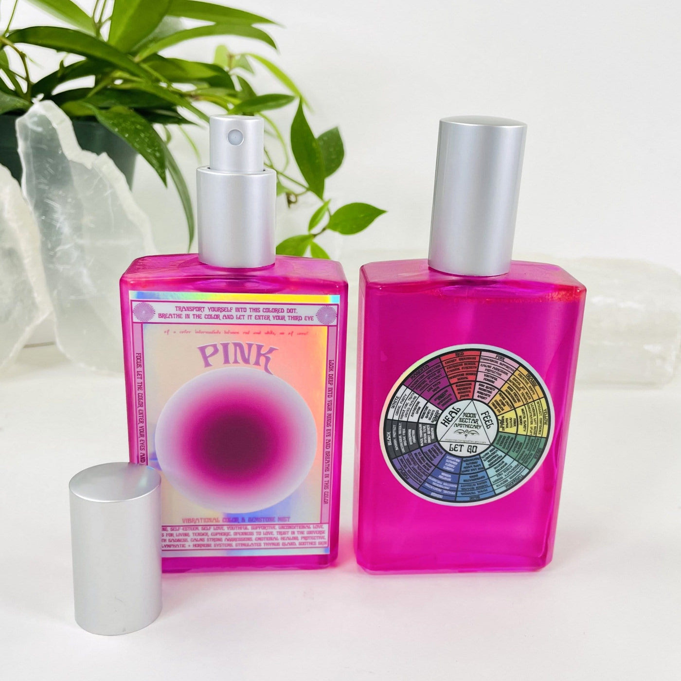 2 bottles of Gemstone Mist - Pink Vibrational Color  with decorations in the background