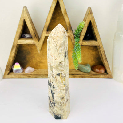 Tourmaline with Feldspar Tower with decorations in the background