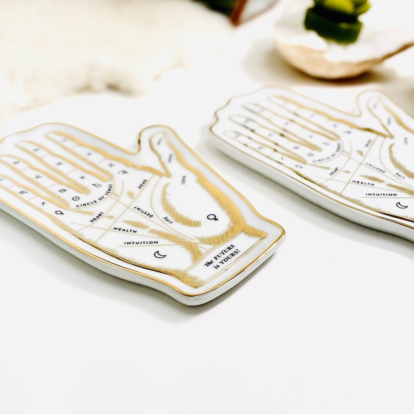 Side angle view of two white and gold Palmistry Hand The Future is Yours Shaped Porcelain Tray